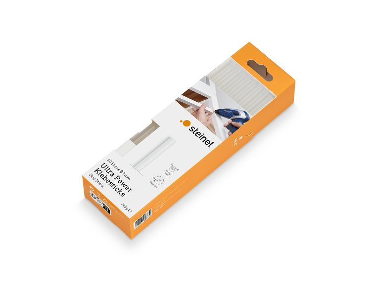 Verpackung mit orangefarbenen Klebestiften und einer Heißklebepistole.
