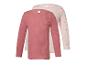 Zwei gerippte Langarmshirts für Kinder, eines rosa und eines hellrosa mit Tupfen.