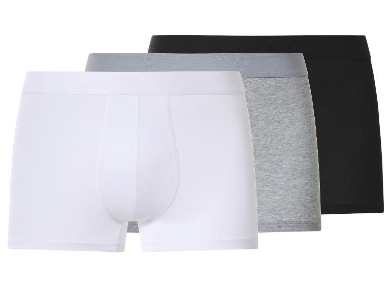 Drei Herren-Boxershorts in Weiß, Grau und Schwarz.