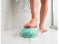 Eine Person unter der Dusche benutzt ein hellgrünes Fußmassagegerät.