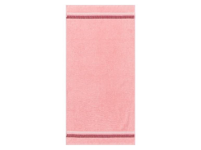 Ein rosa Handtuch mit rotem Rand.
