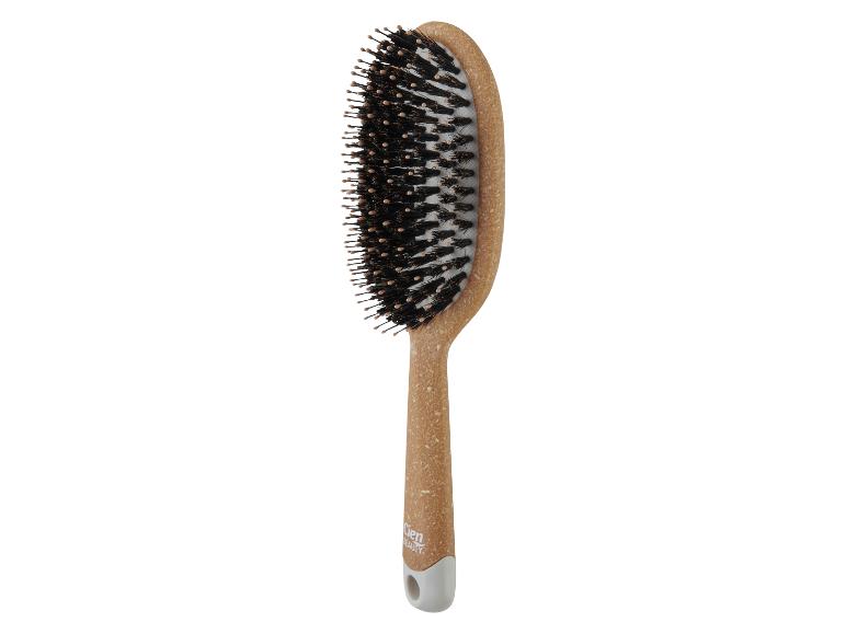 Eine Cien Beauty Haarbürste mit Holzgriff.