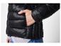 Schwarze Steppjacke mit Hand in der Tasche.