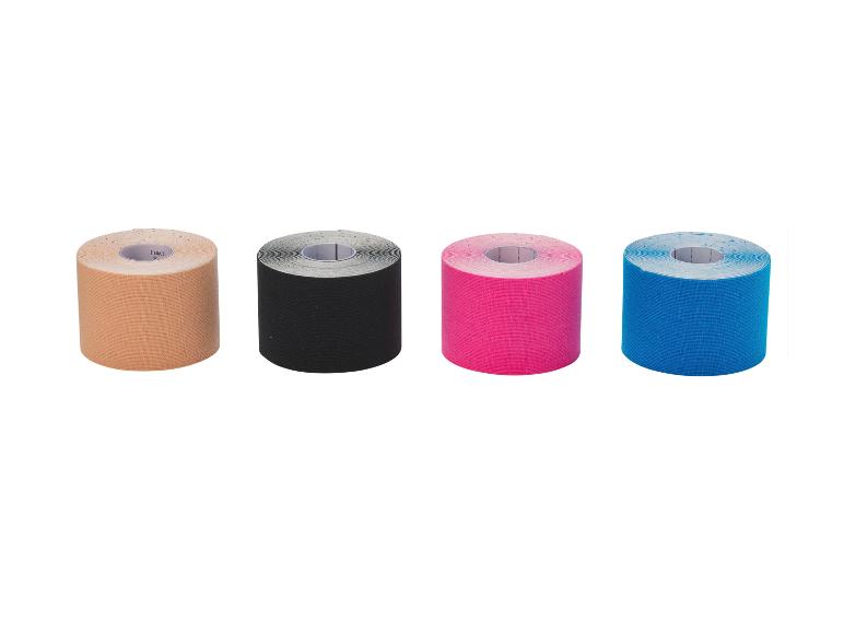 Vier Rollen Kinesiologie-Tape in verschiedenen Farben: Beige, Schwarz, Pink und Blau.