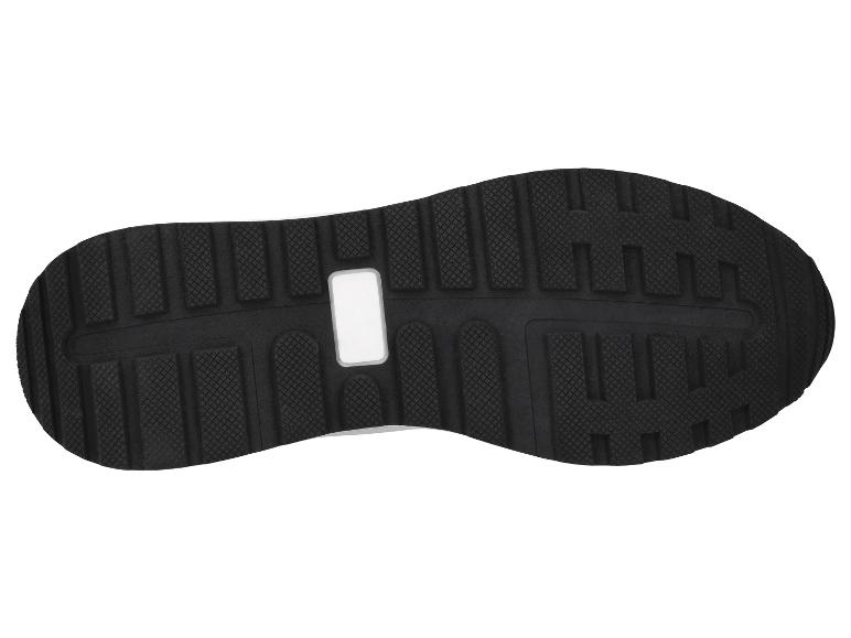 Schwarze Schuhsohle mit gemusterter Oberfläche und weißem rechteckigem Einsatz.