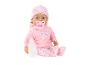 Babypuppe in rosa Kleidung mit Herzen, Schnuller und Fläschchen.