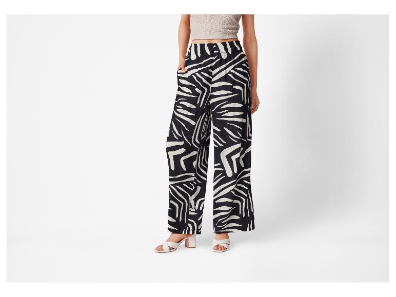 Weite Hose mit schwarz-weiß Zebra-Muster und hohen Schuhen.