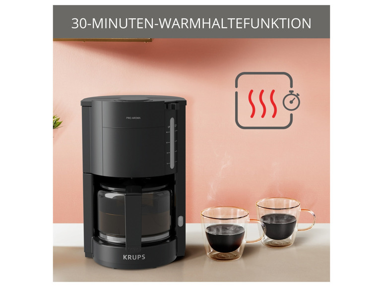 Eine schwarze Krups Kaffeemaschine mit Warmhaltefunktion und zwei gläserne Tassen Kaffee.