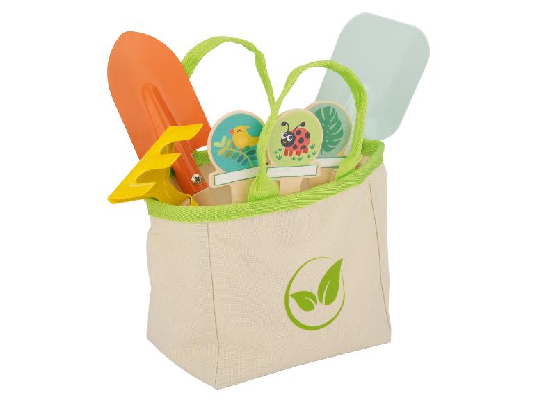 Eine Canvas-Tasche mit Gartengeräten, darunter eine Schaufel, eine Harke und Pflanzensticker.