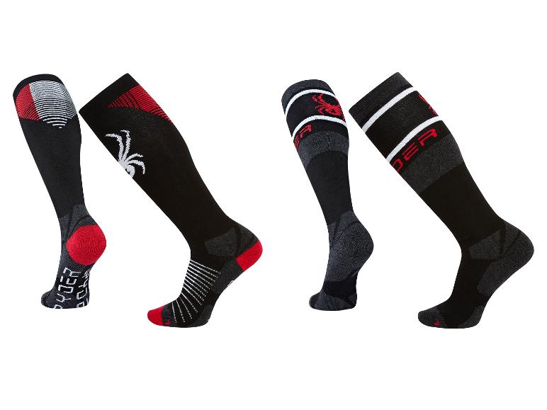 Vier schwarze Skisocken mit roten und weißen Details und Spinnenlogo.