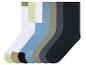 Sechs Paar Socken in verschiedenen Farben, darunter Schwarz, Grau, Weiß, Beige, Hellblau und Grün.