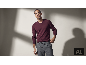 Mann in einem eleganten weinroten V-Ausschnitt-Pullover und grauer Hose.