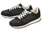 Ein Paar schwarze Sportschuhe mit weißen Schnürsenkeln und Sohlen.