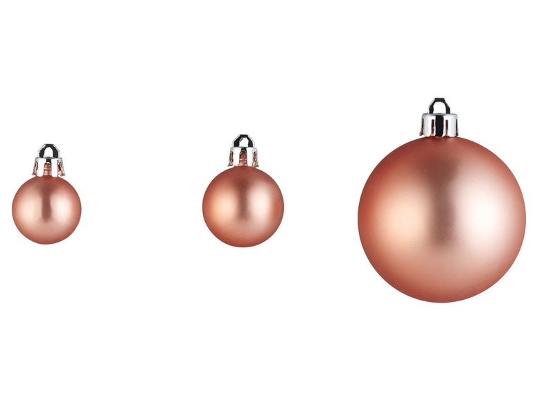 Drei rosafarbene Weihnachtskugeln, zwei kleine und eine große