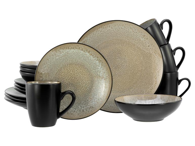 Steingut-Geschirrset mit schwarzen und beigen Tellern, Schalen und Tassen mit gesprenkeltem Muster.