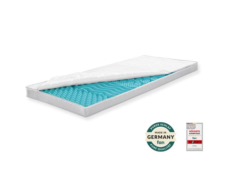 Matratze mit abnehmbarem Bezug, der den blauen, wellenförmigen Schaumkern zeigt, mit Qualitätssiegeln.
