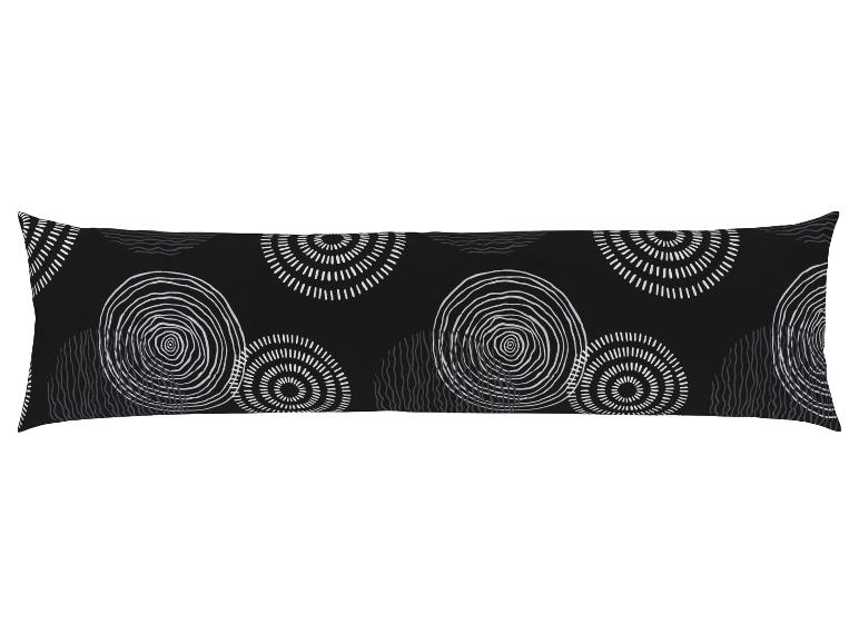 Ein schwarzes Kissen mit weißen Kreisen und Streifen.