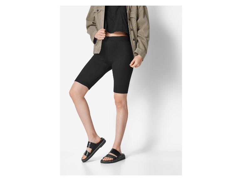 Frau in schwarzen Radlerhosen und schwarzen Sandalen.