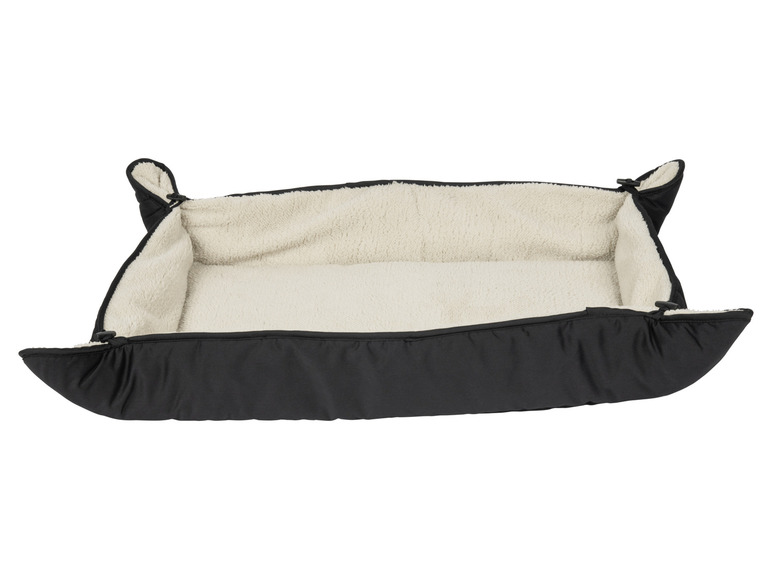 Ein schwarzes Hundebett mit einem weichen, beigen Futter.