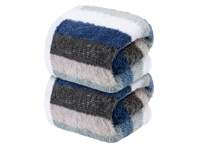 Zwei gerollte Handtücher mit Streifen in Blau, Grau und Weiß.