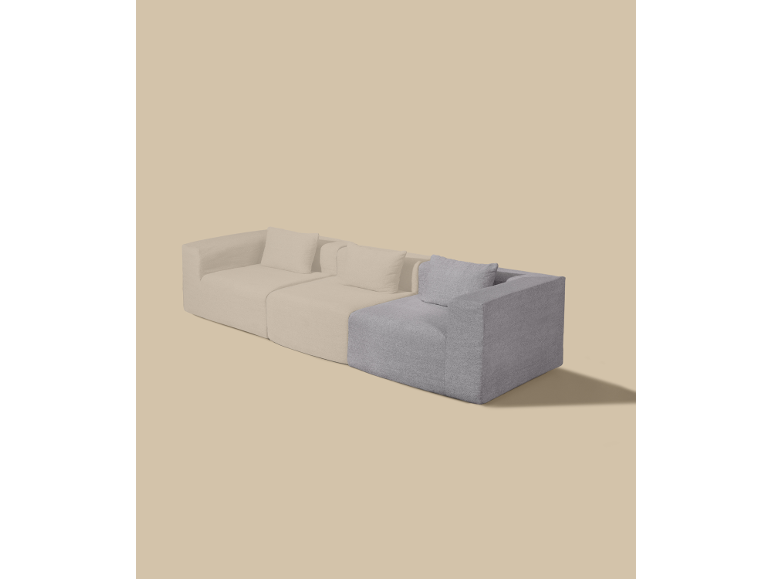Modulares Sofa mit hellbeigen und grauen Abschnitten auf beigem Hintergrund.