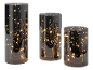 Drei Rauchglaszylinder mit dekorativen LED-Lichterketten im Inneren.