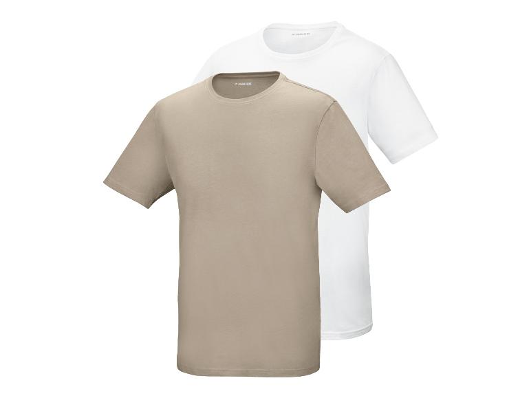 Zwei Kurzarm-T-Shirts, eines beige und eines weiß, übereinandergelegt.