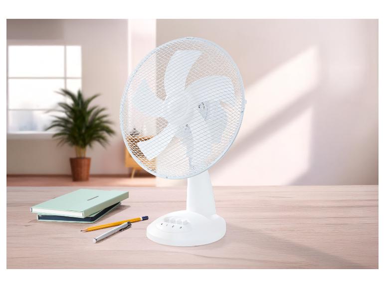 Tischventilator mit Notizbüchern und Stiften auf einem Holztisch