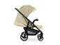 Beiger Kinderwagen mit schwarzem Gestell und Rädern, mit „SHOP N CARE“-Etikett.
