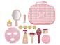 Ein Spielzeug-Gesichtsbehandlungsset mit Spiegel, Maske und Cremes in einer rosa Tasche.
