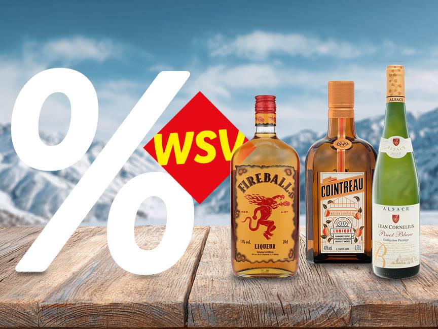 WSV-Angebot mit Fireball Likör, Cointreau und Jean Cornelius Pinot Blanc Wein auf Holztisch vor Winterlandschaft