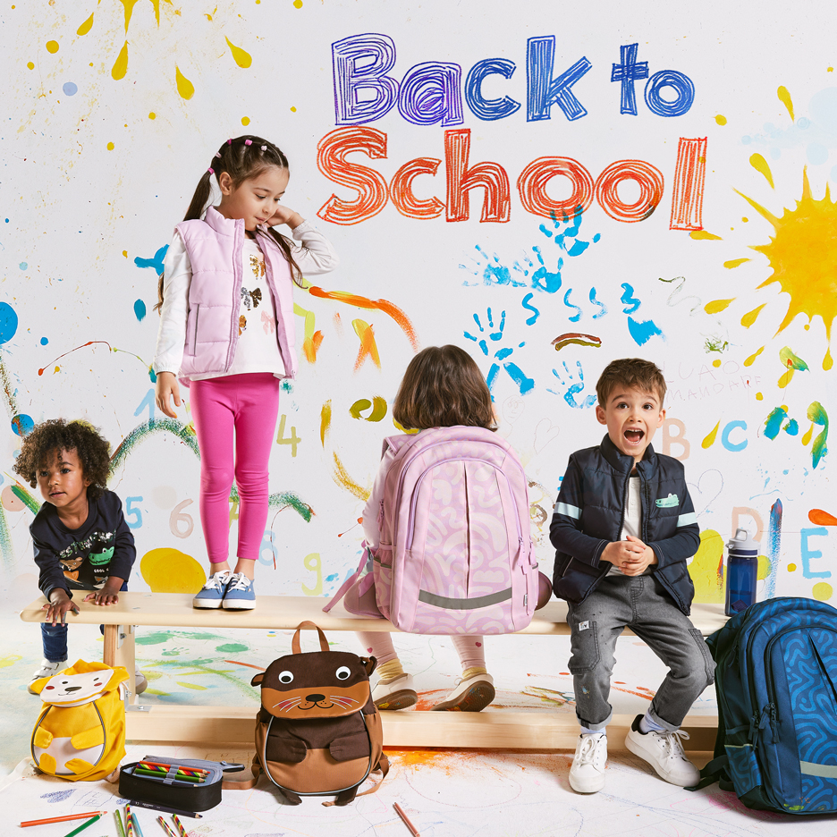Vier Kinder mit Rucksäcken und Schulmaterial, mit „Back to School“-Text auf farbenfrohem Hintergrund.