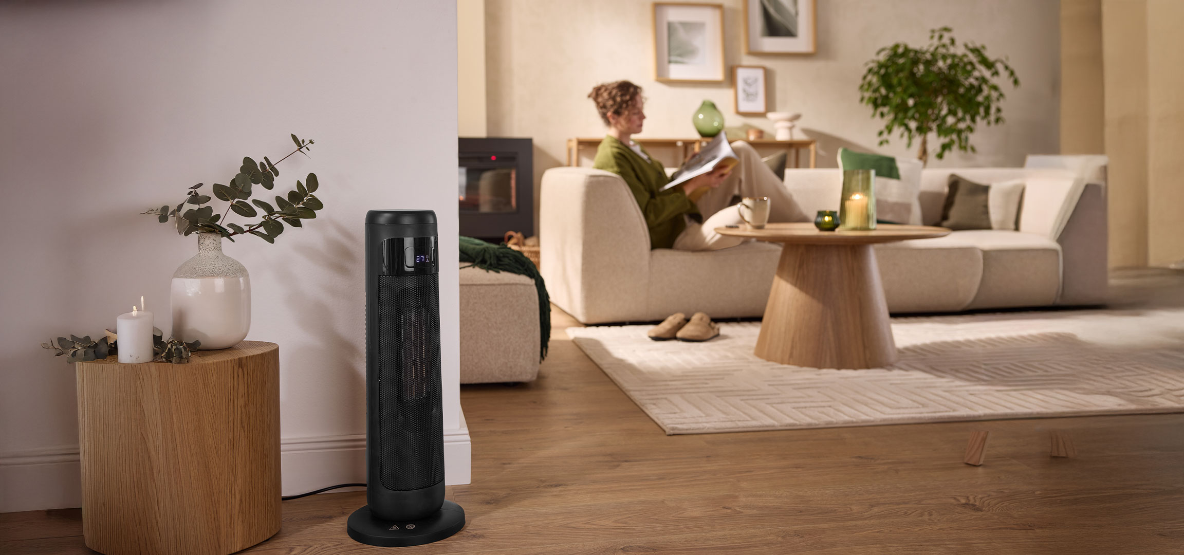 AI-generiert: Ein moderner schwarzer Turmheizlüfter in einem gemütlichen Wohnzimmer mit einer Person auf dem Sofa.